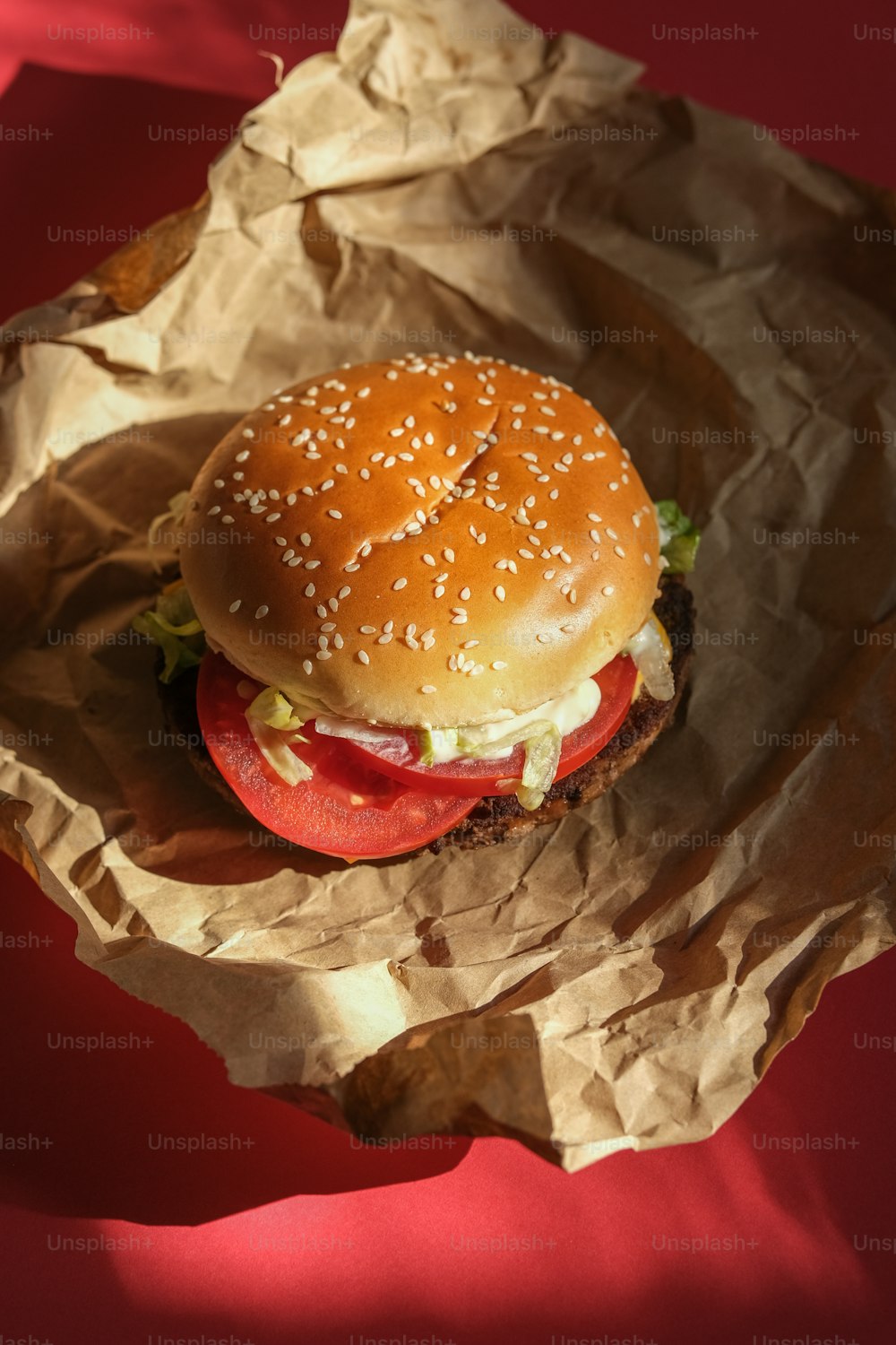 a hamburger sitting on top of a piece of wax paper