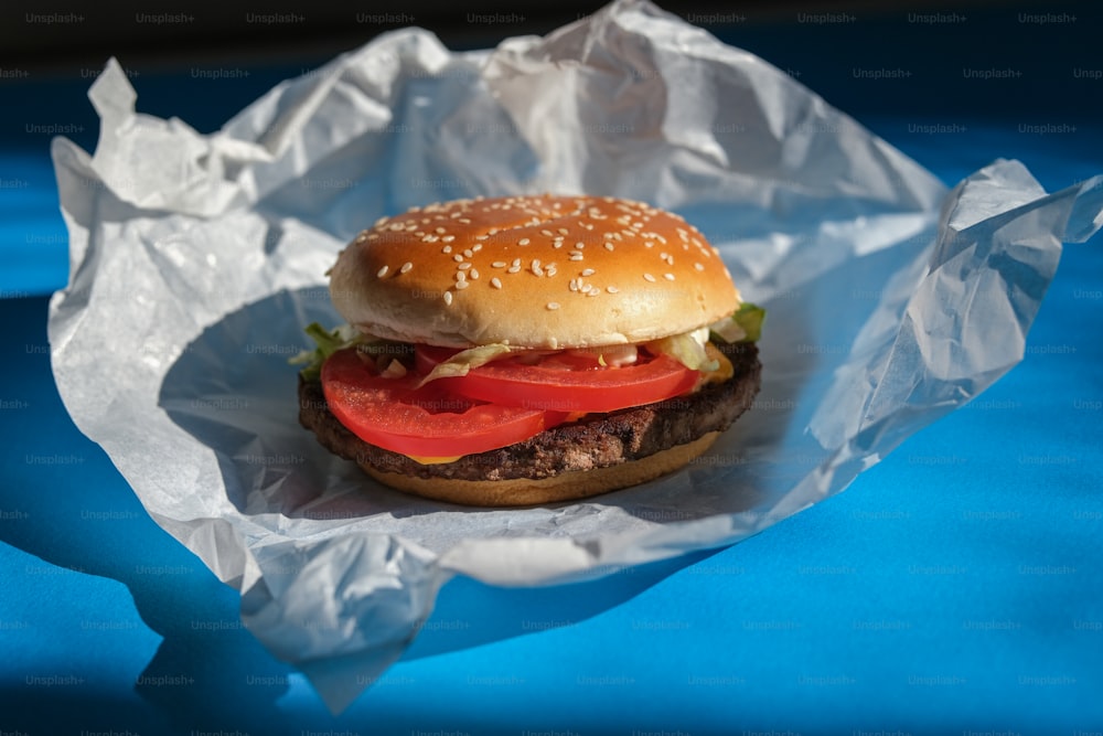 a hamburger with a tomato and lettuce on it