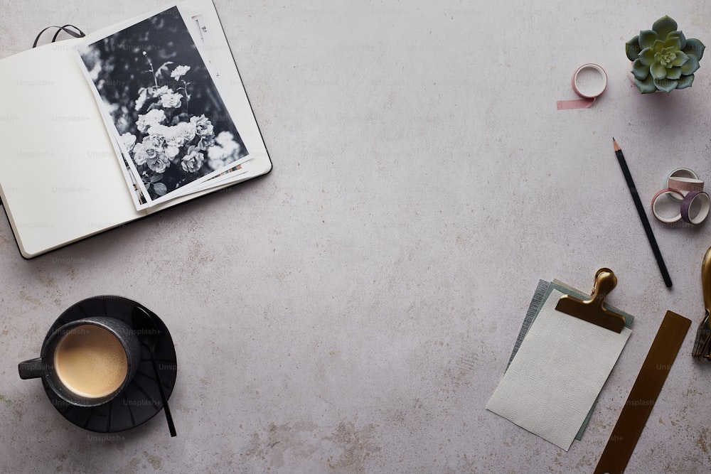 a table with a cup of coffee and a notebook