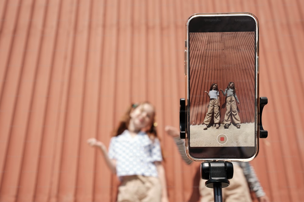 a person taking a picture of a group of people on a cell phone