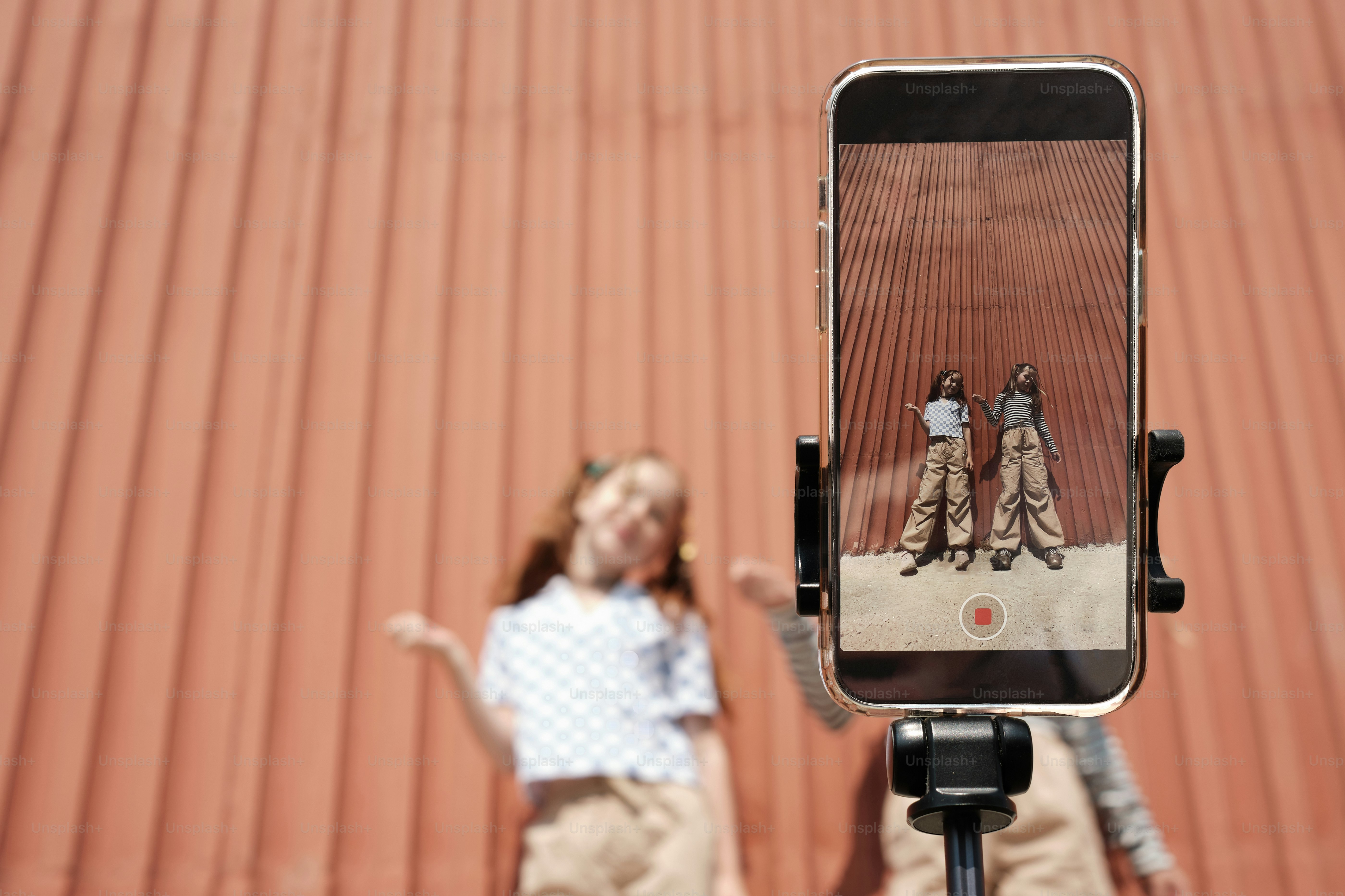 two young girls dancing in front of a camera