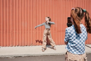 a woman taking a picture of a little girl