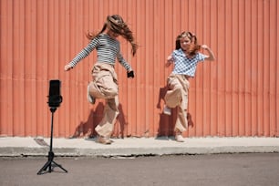 a couple of girls that are jumping in the air