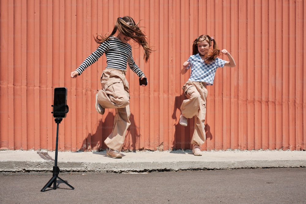 a couple of girls that are jumping in the air