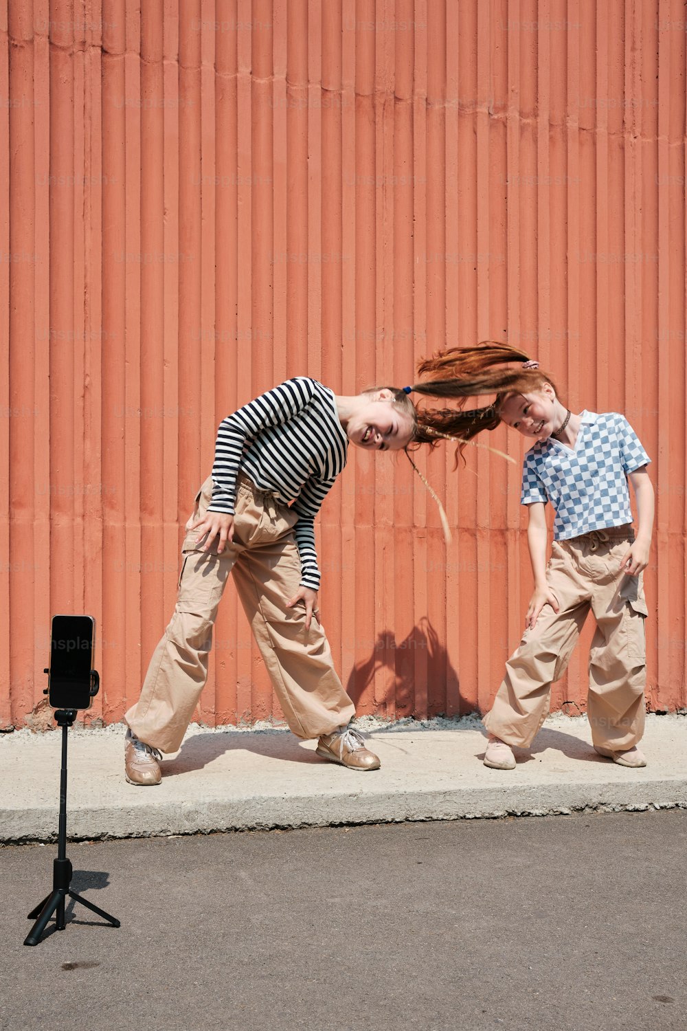 a couple of people that are walking down a street