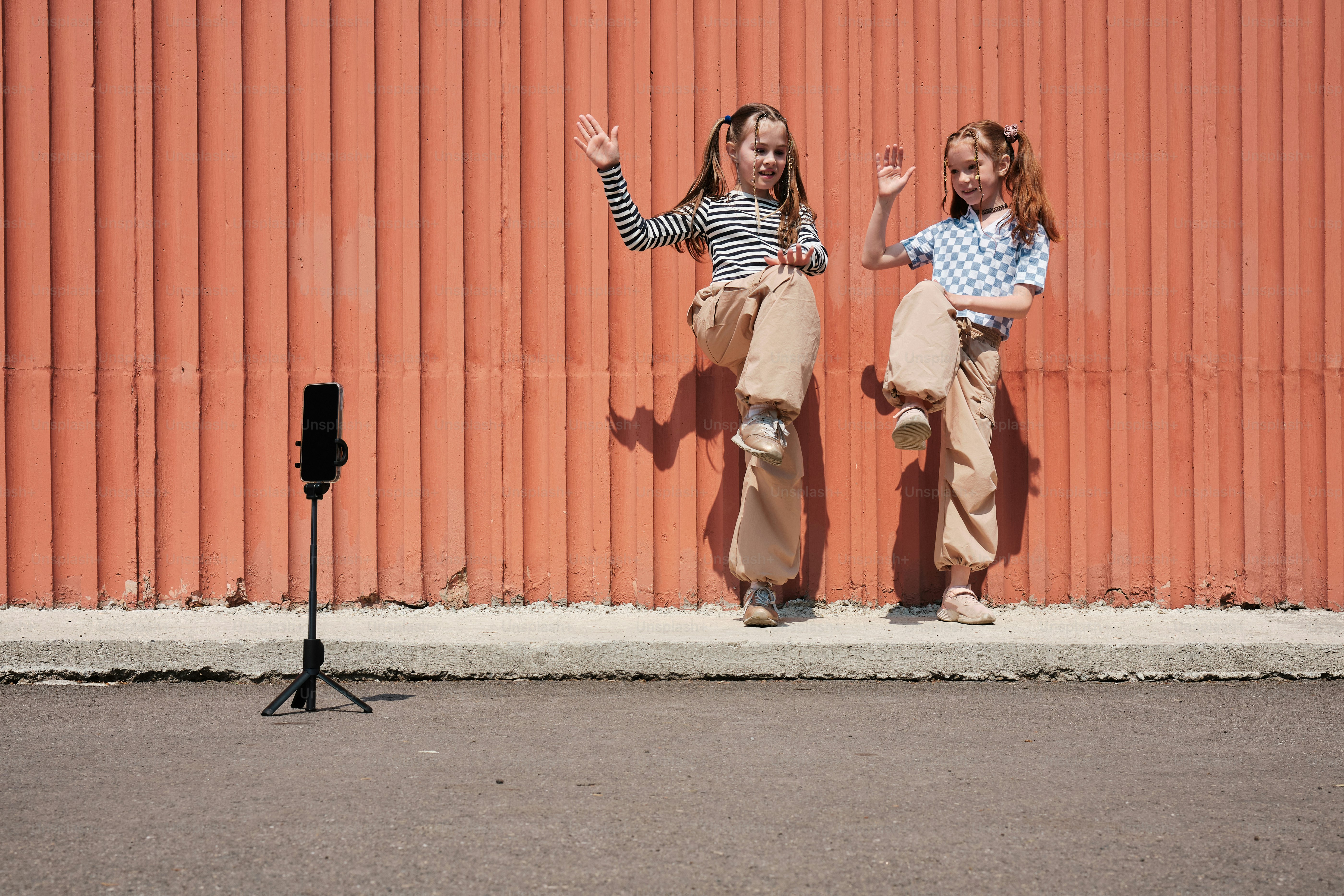 two young girls dancing in front of a camera