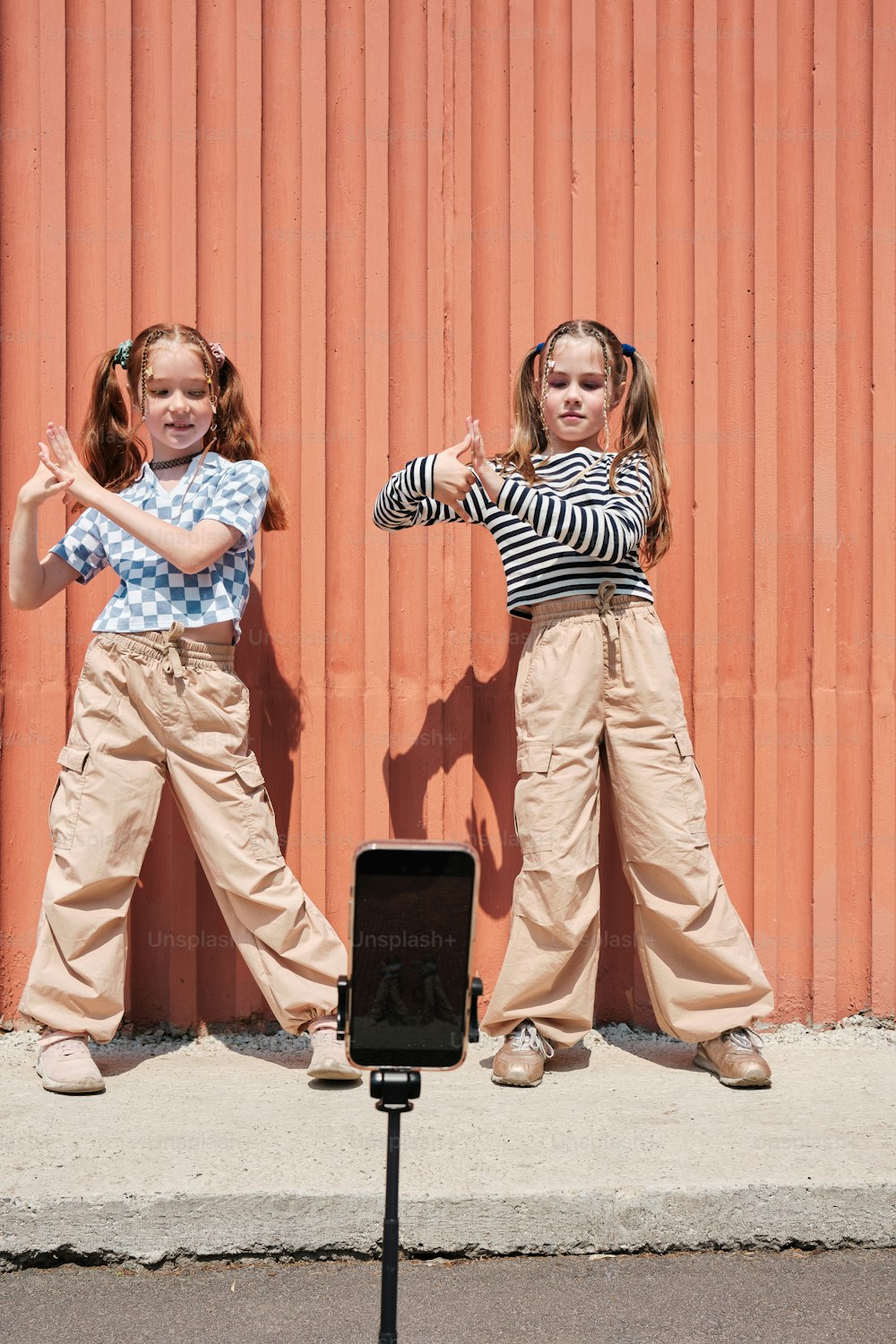 two young girls standing next to each other