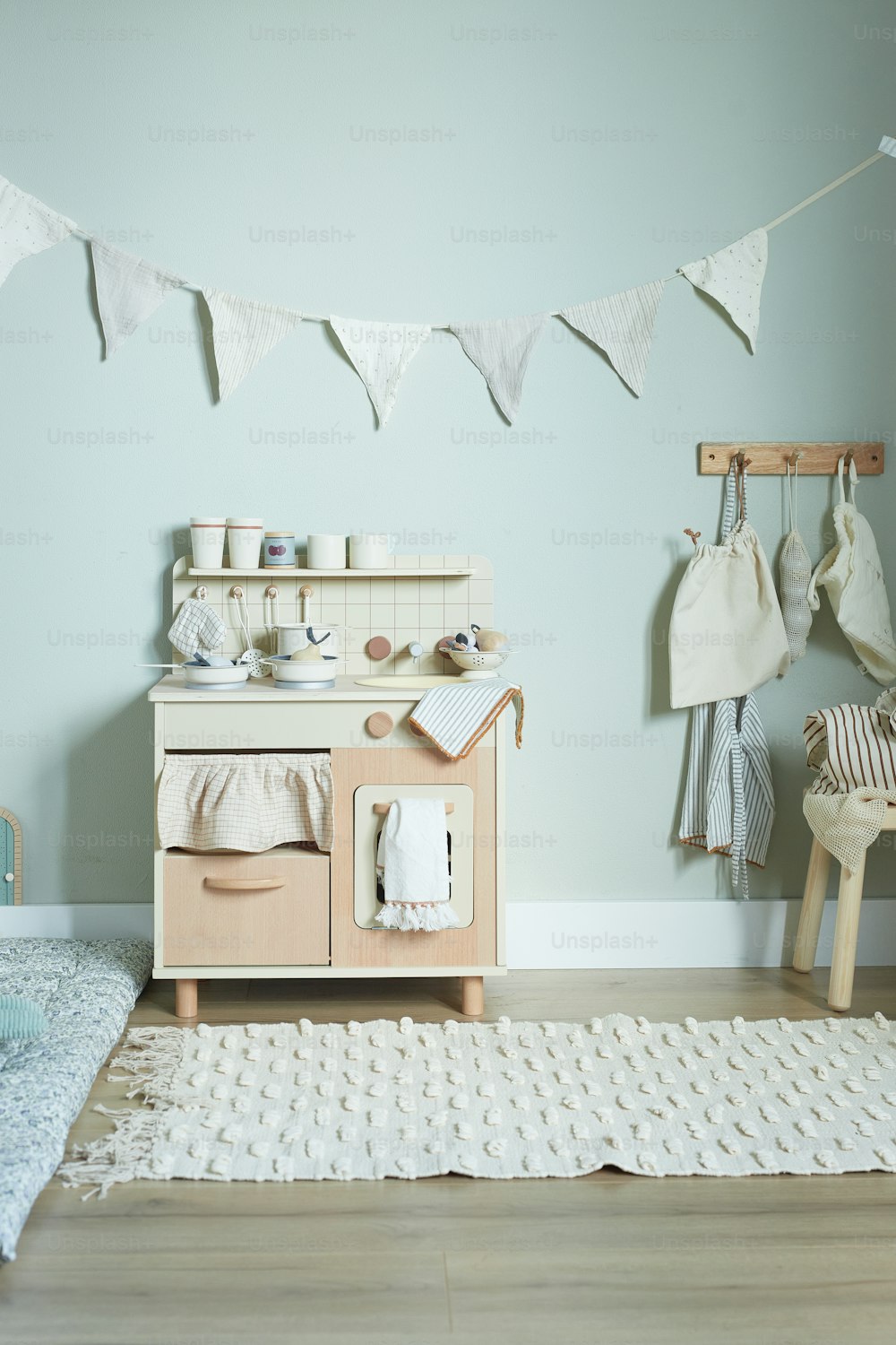 a child's play kitchen in a blue room