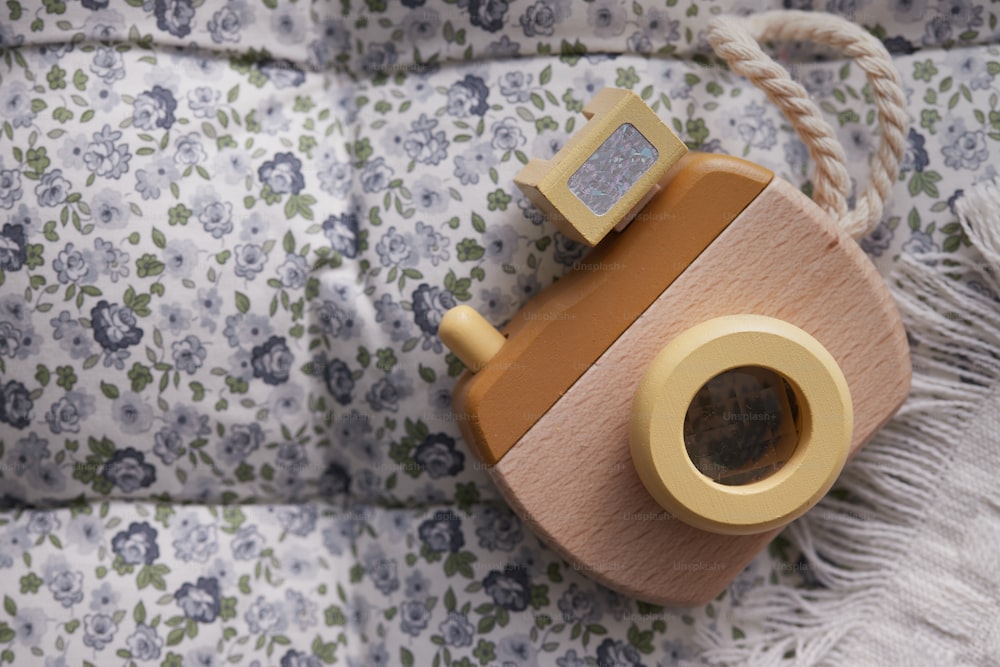 a toy camera sitting on top of a blanket
