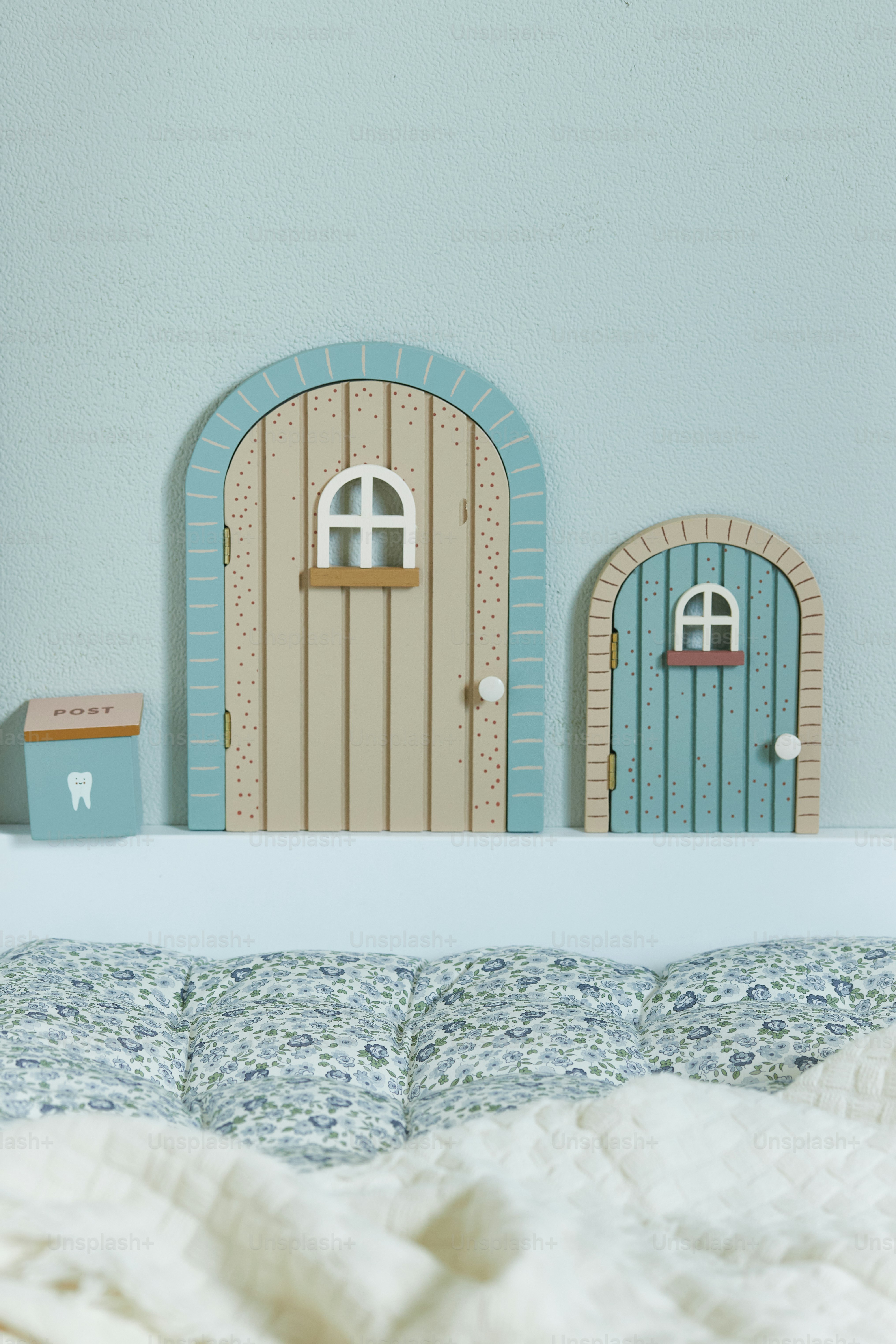 a bed with a white comforter and a blue door