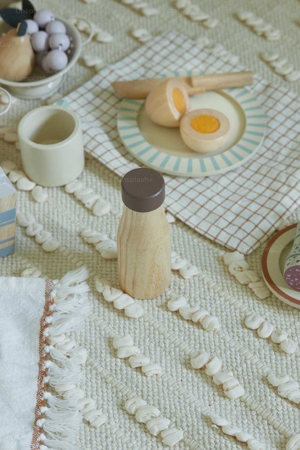 a table topped with plates and cups filled with food