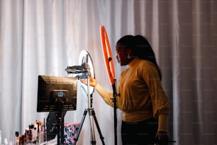 a woman standing in front of a camera