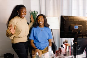 two women standing next to each other in a room