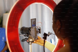 a woman holding a camera in front of a mirror