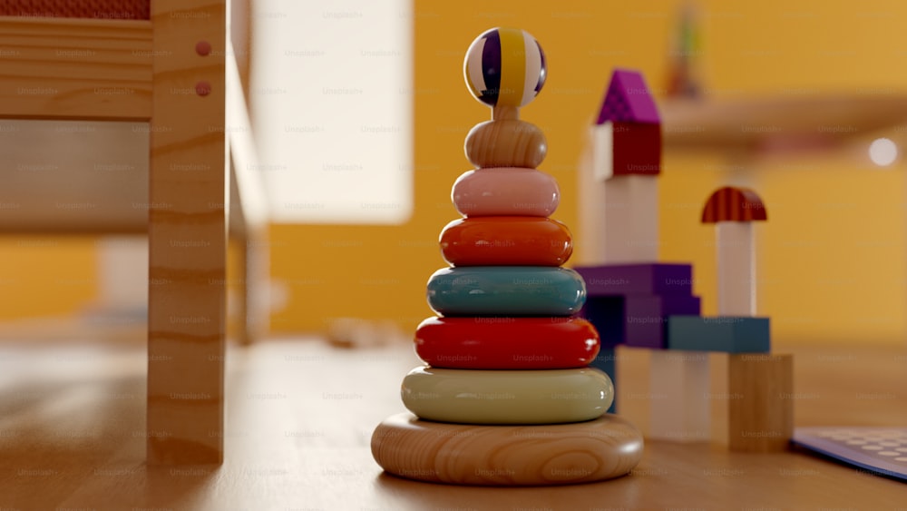 a stack of colorful toys sitting on top of a wooden table