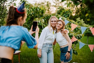 two women taking a picture of themselves in an apple orchard