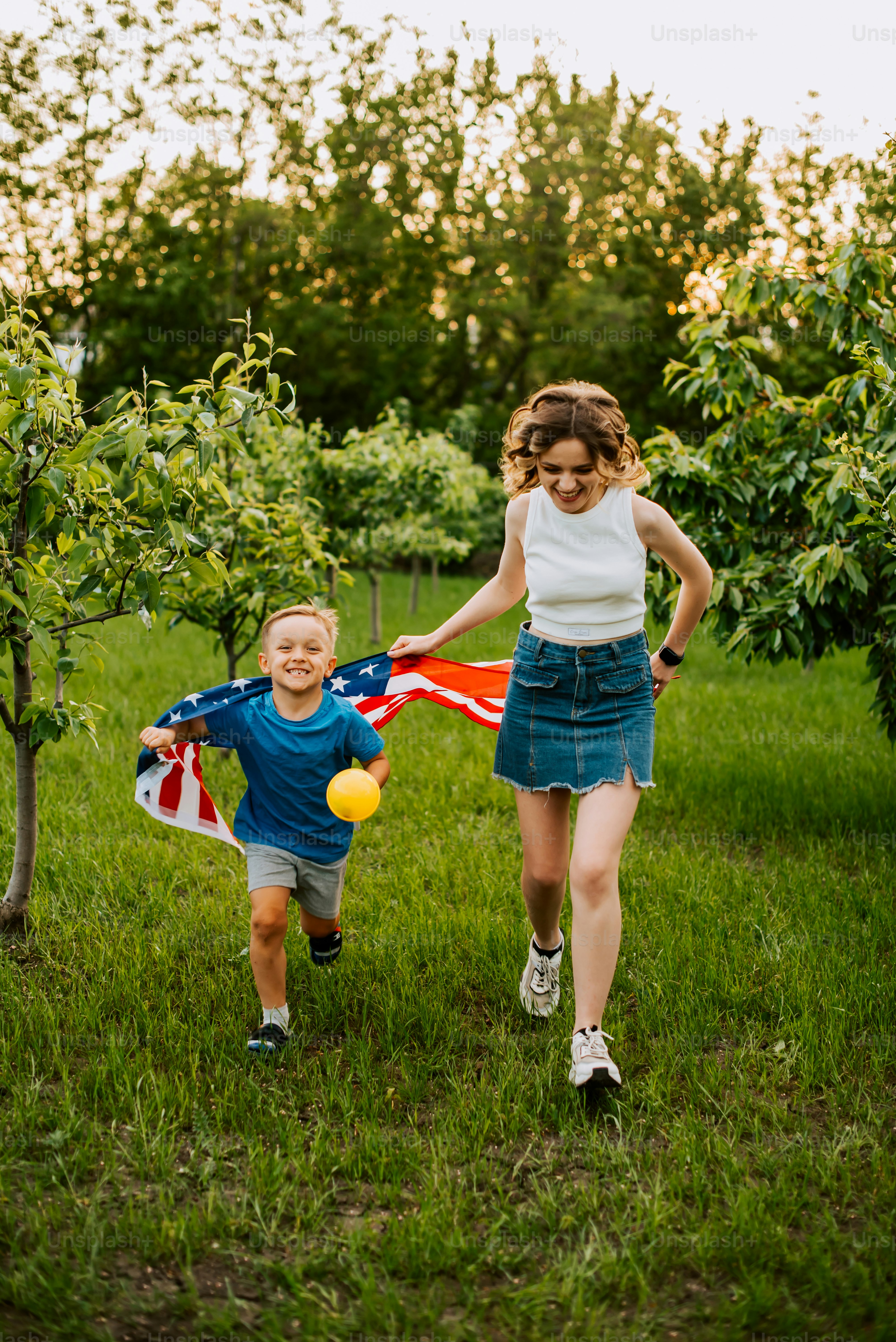 a little boy and a little girl playing with a kite