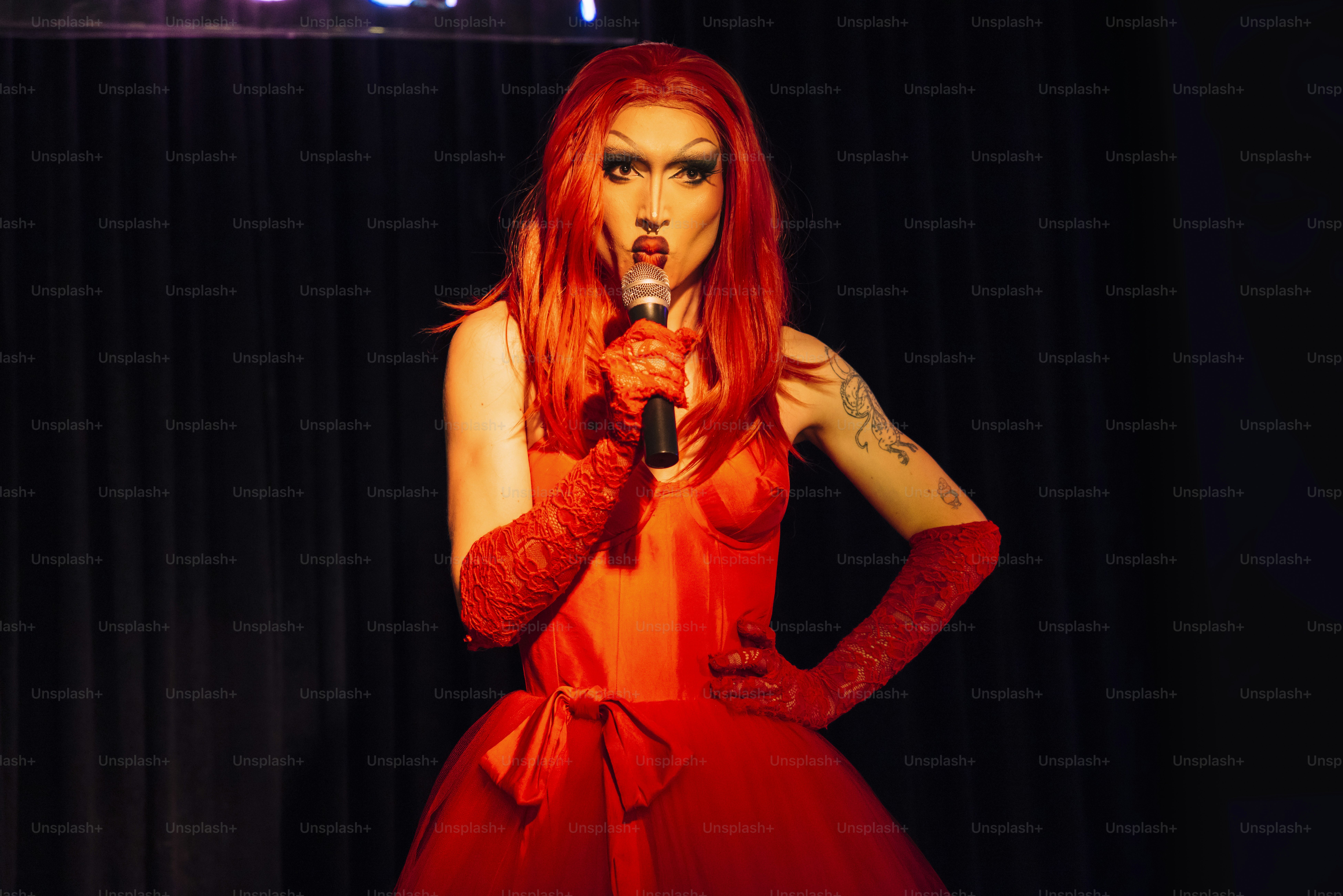 a woman in a red dress holding a microphone