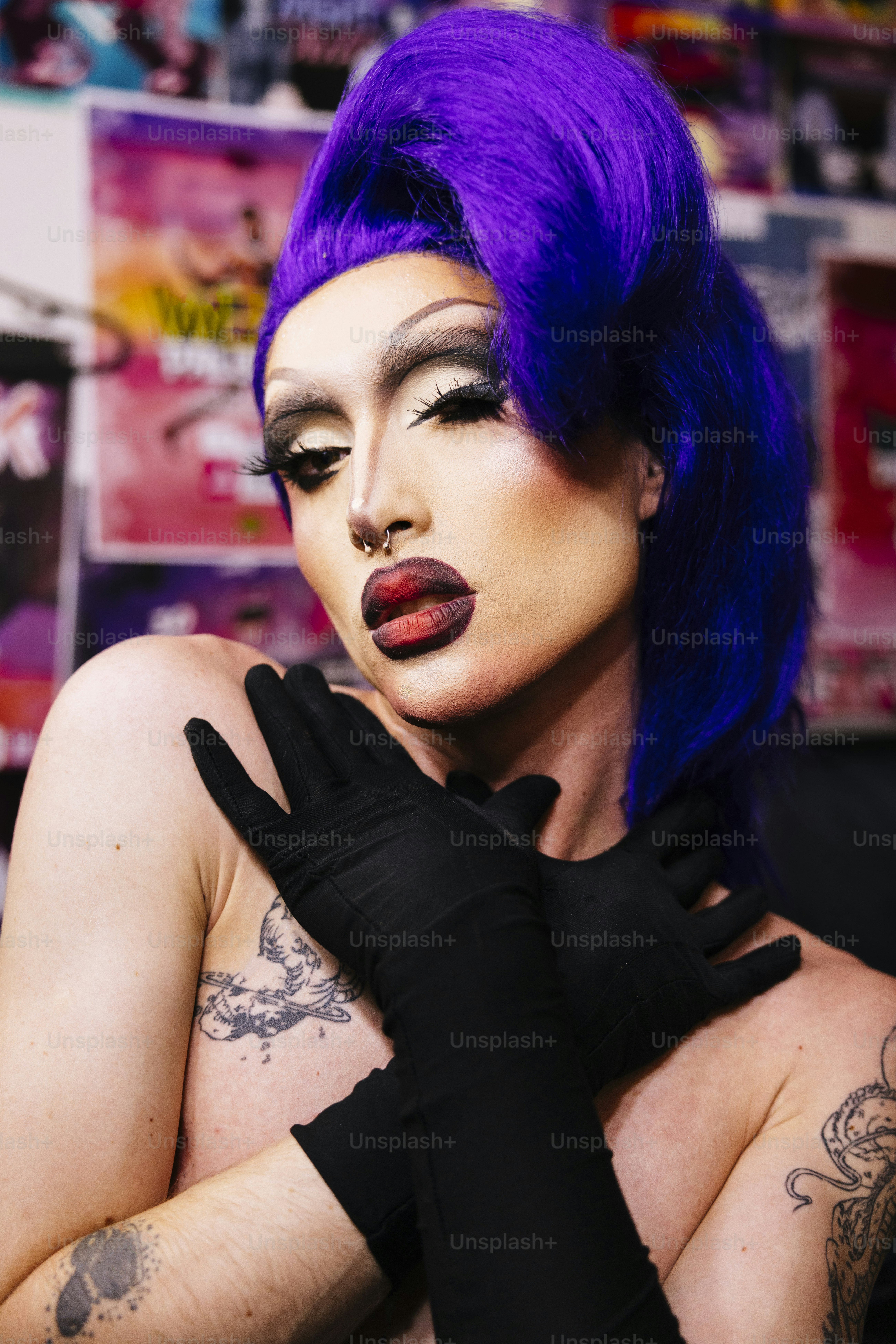 a woman with purple hair and black gloves
