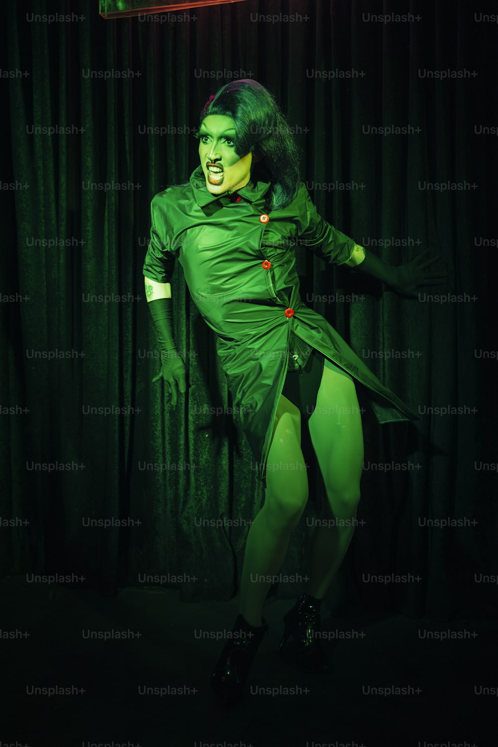 a woman dressed in a green costume posing for a picture