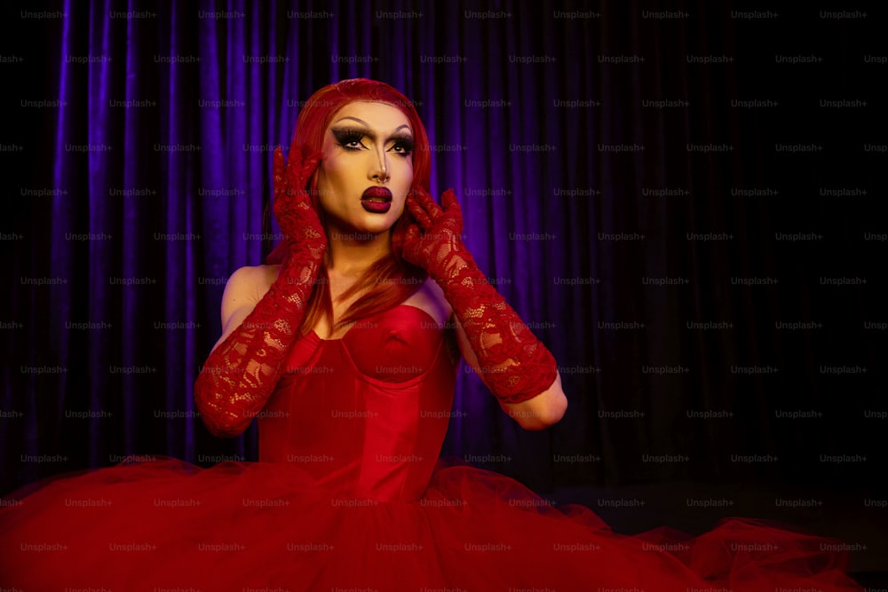 a woman in a red dress and red gloves