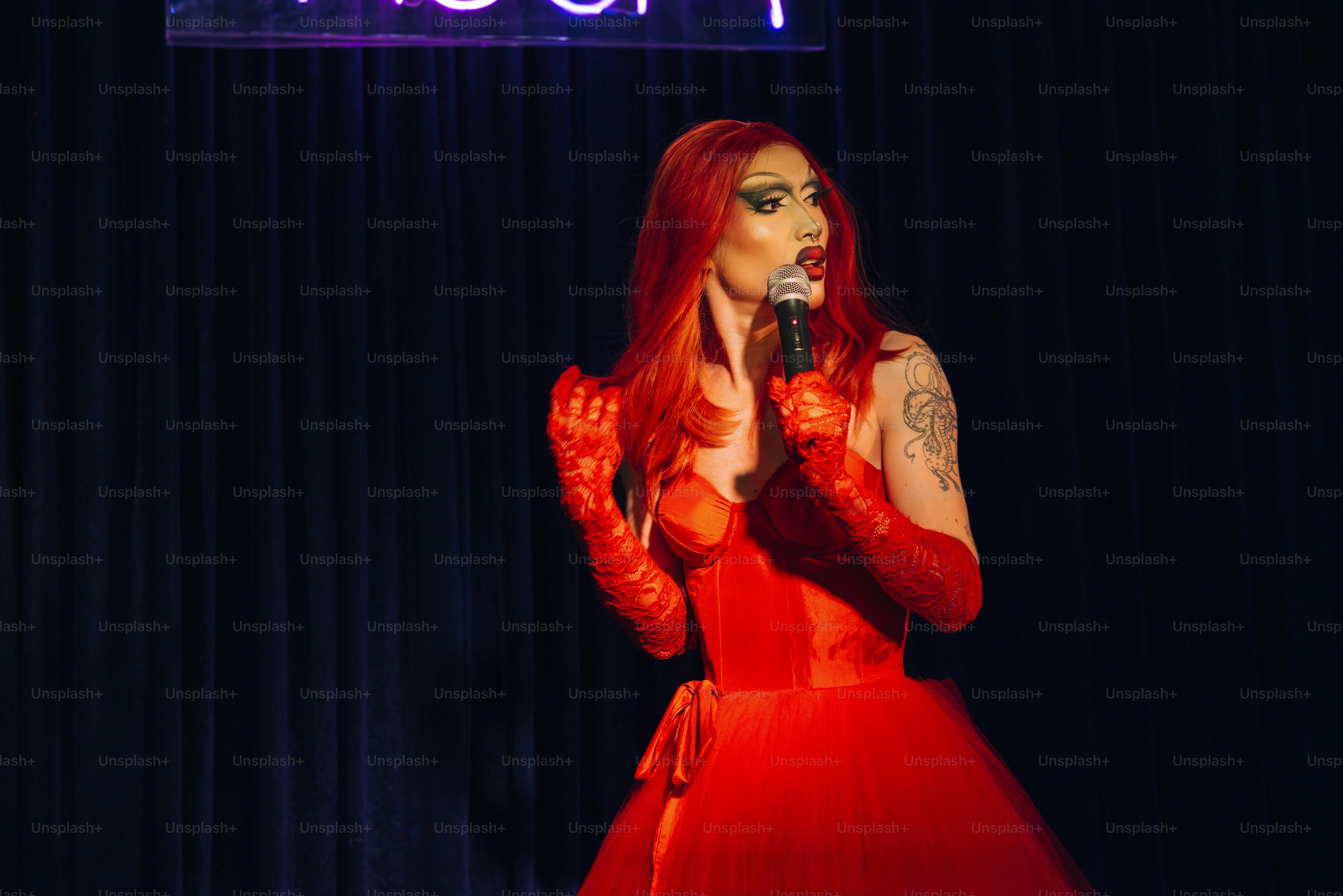 a woman in a red dress holding a microphone