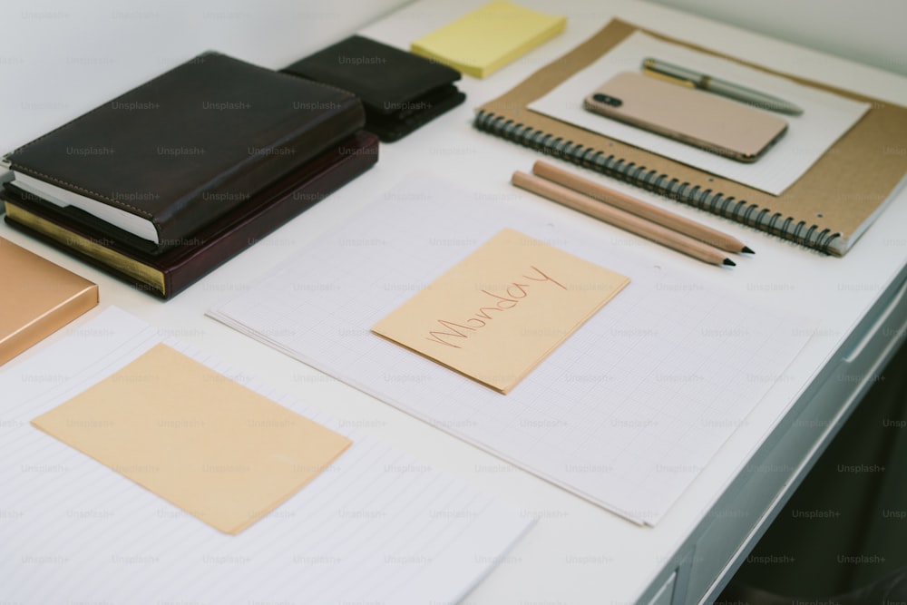 a table topped with lots of notebooks and papers