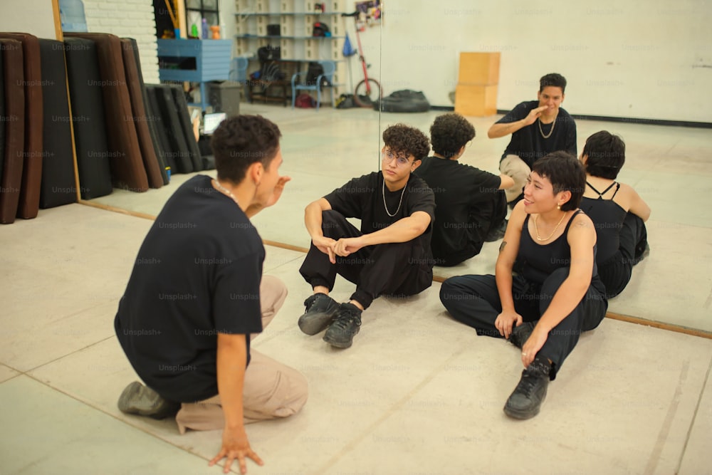 a group of young men sitting on the floor