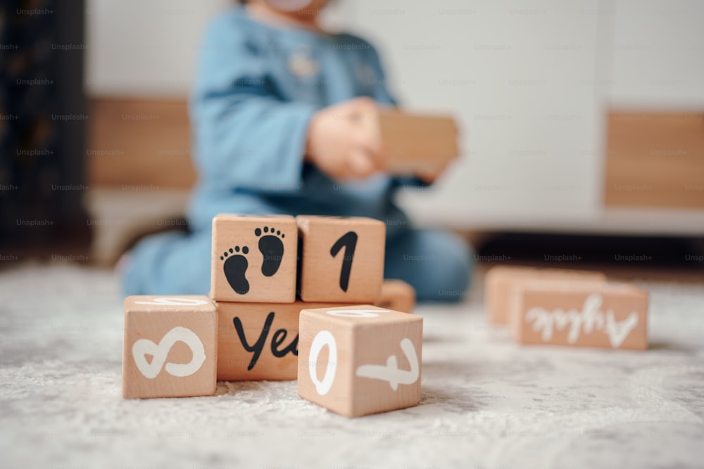 un bambino che gioca con blocchi di legno con numeri su di essi