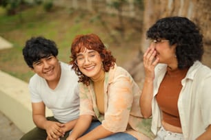 a group of three people sitting next to each other