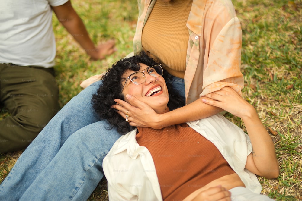 a woman laying on the ground next to a man