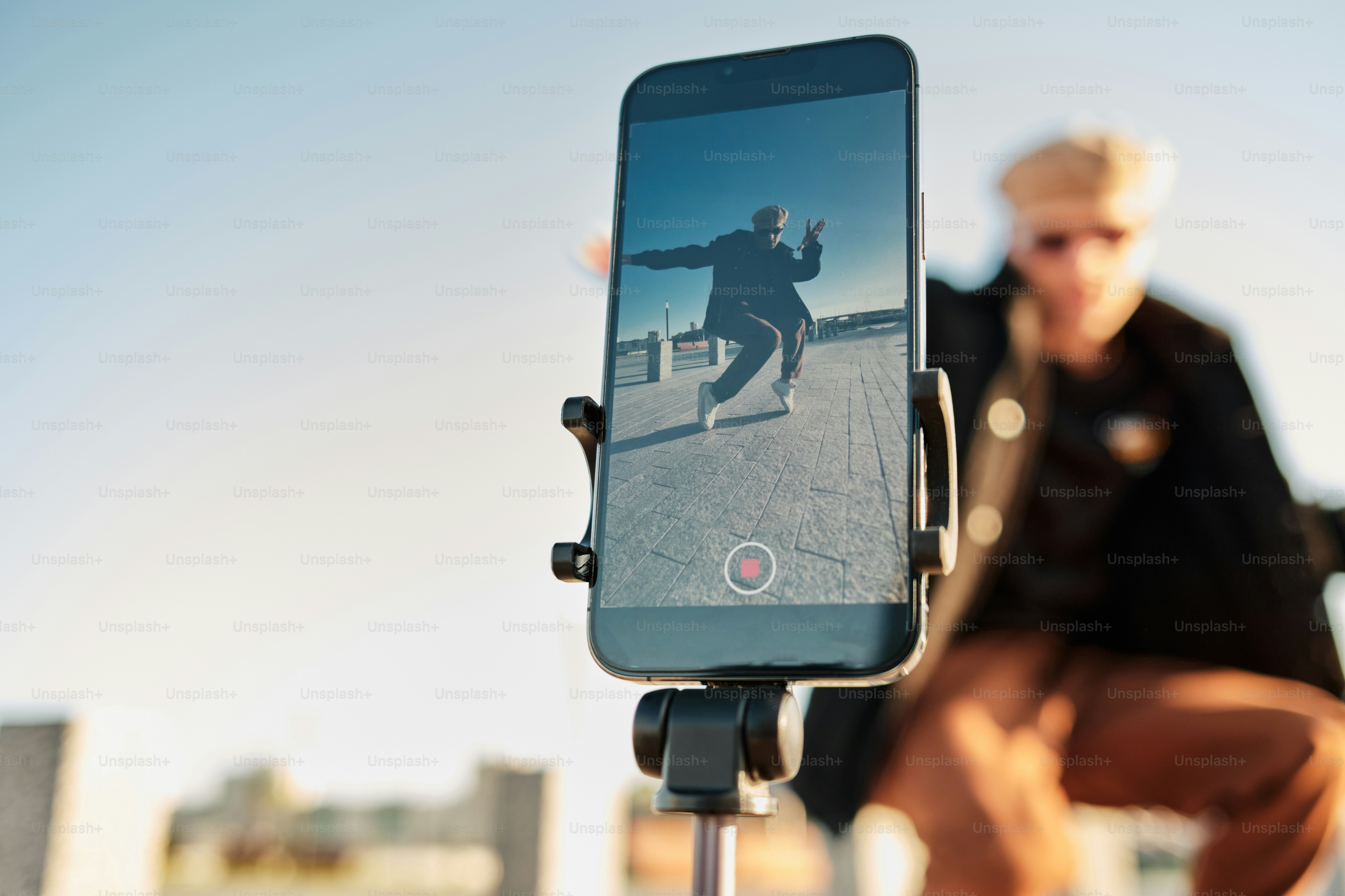 a man riding a skateboard on top of a cell phone