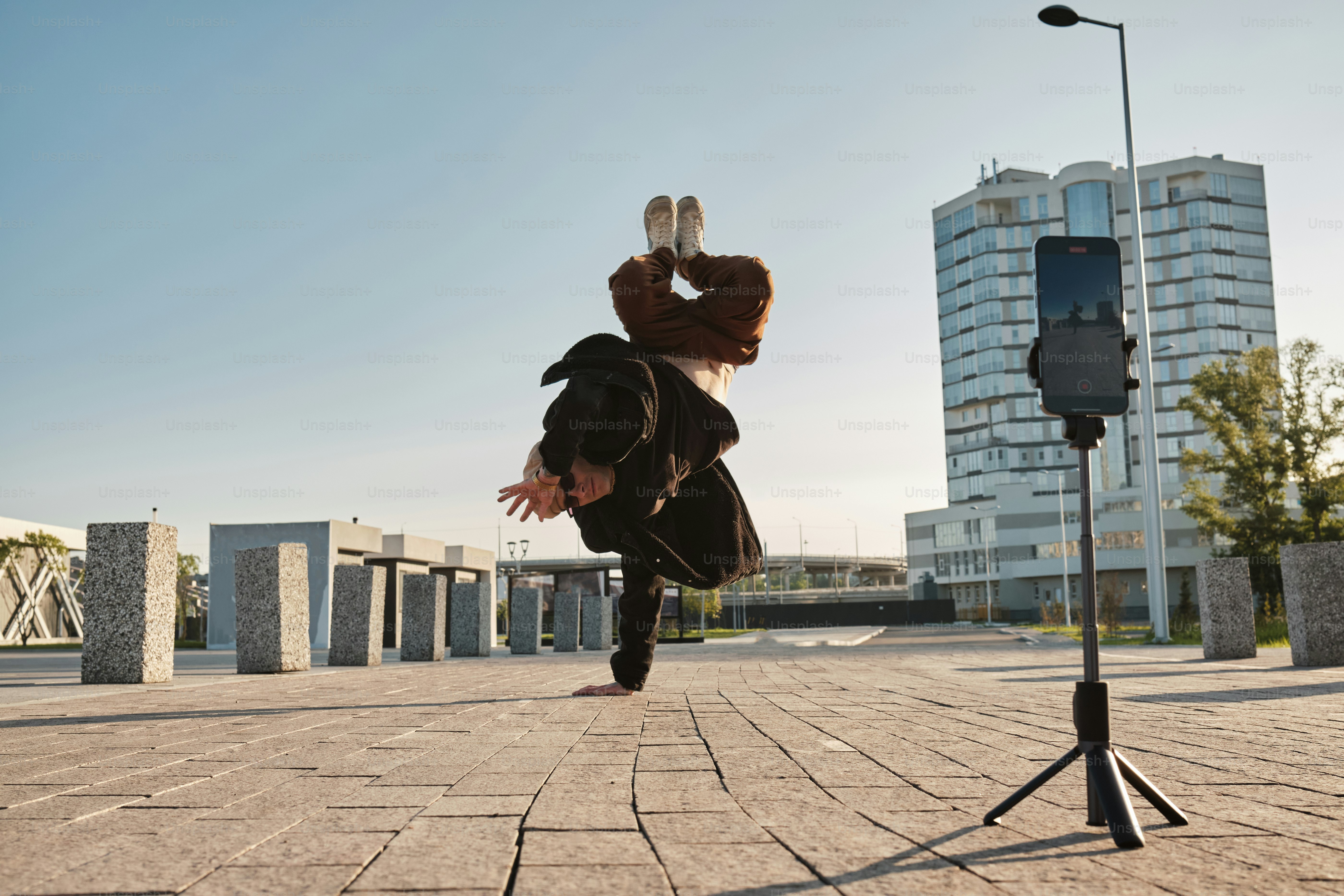 a man is doing a handstand on a street