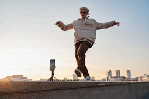 a man riding a skateboard on top of a cement wall