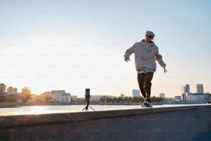 a man riding a skateboard on top of a cement wall