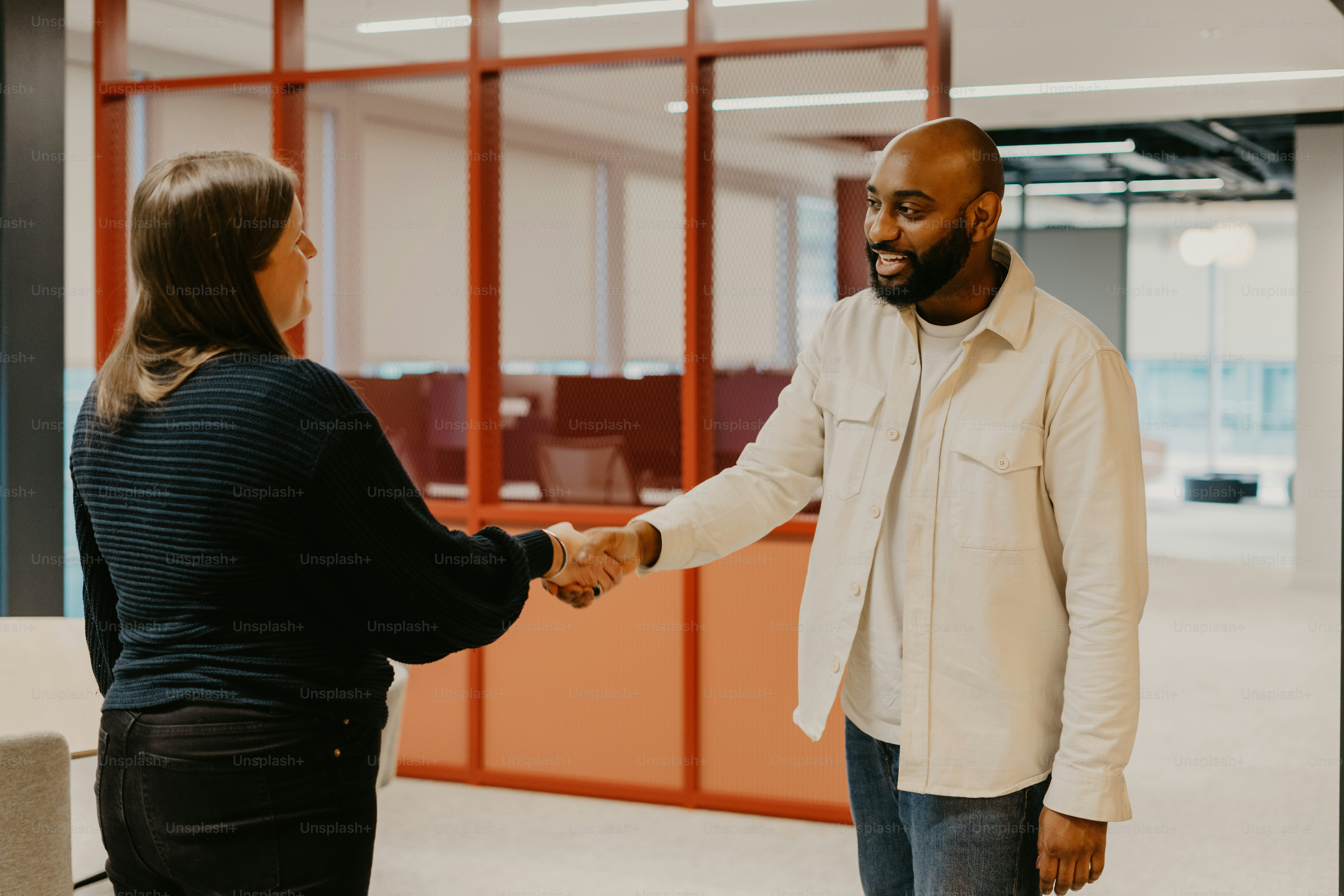 a man and a woman shaking hands in an office