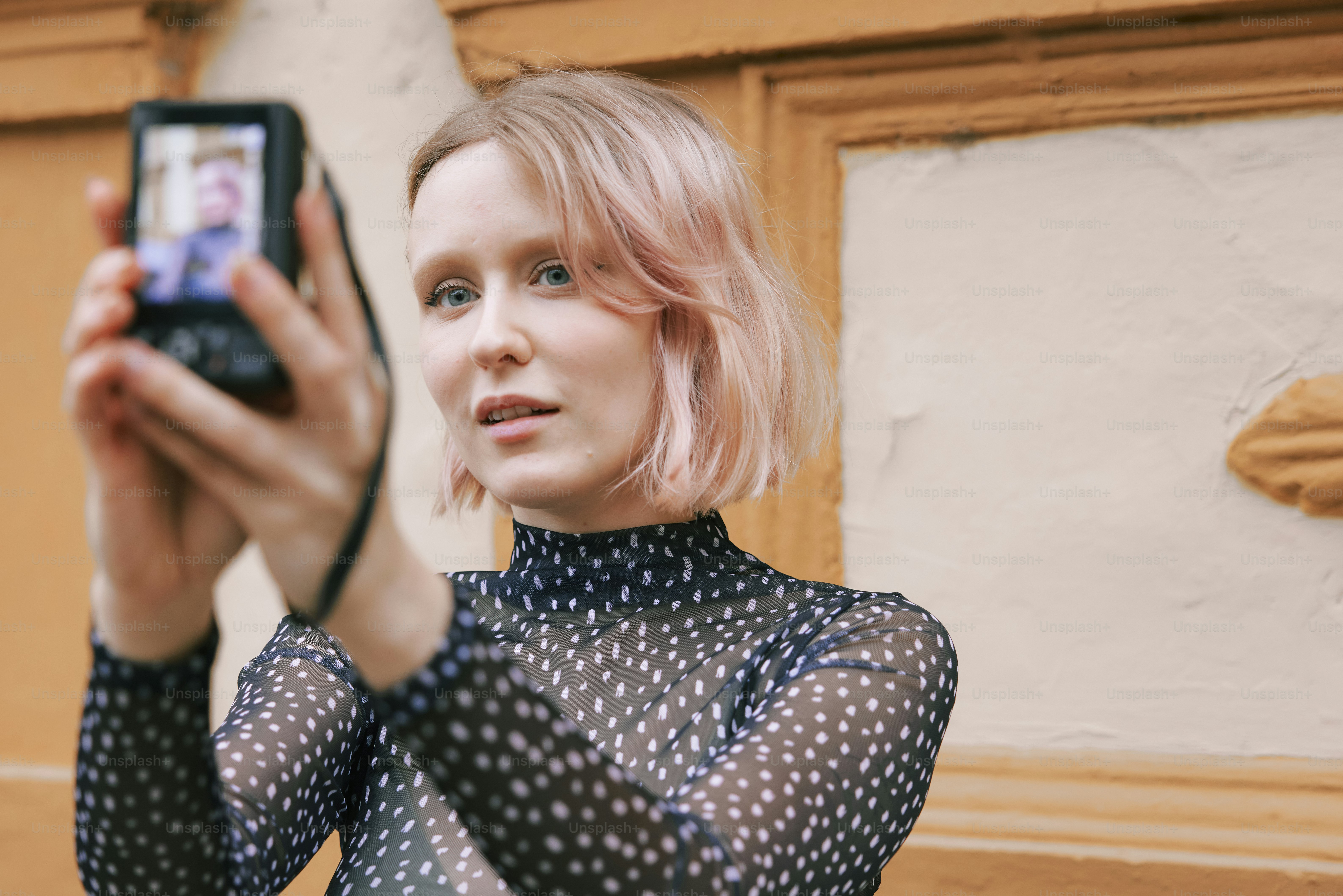 a woman taking a picture with her cell phone