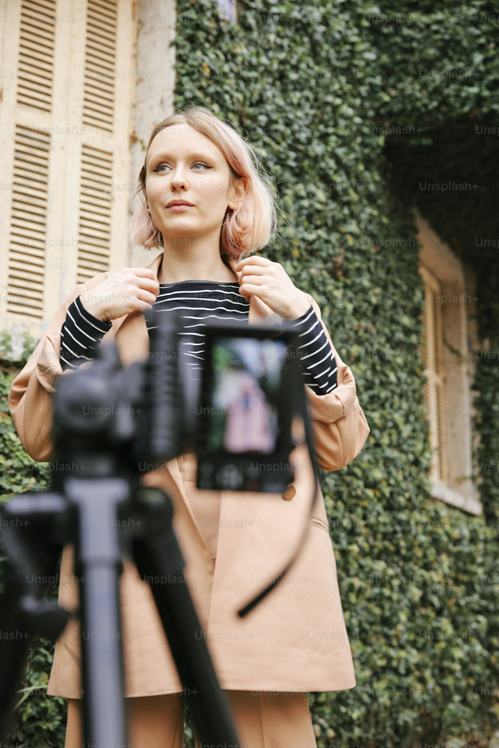 a woman standing in front of a camera