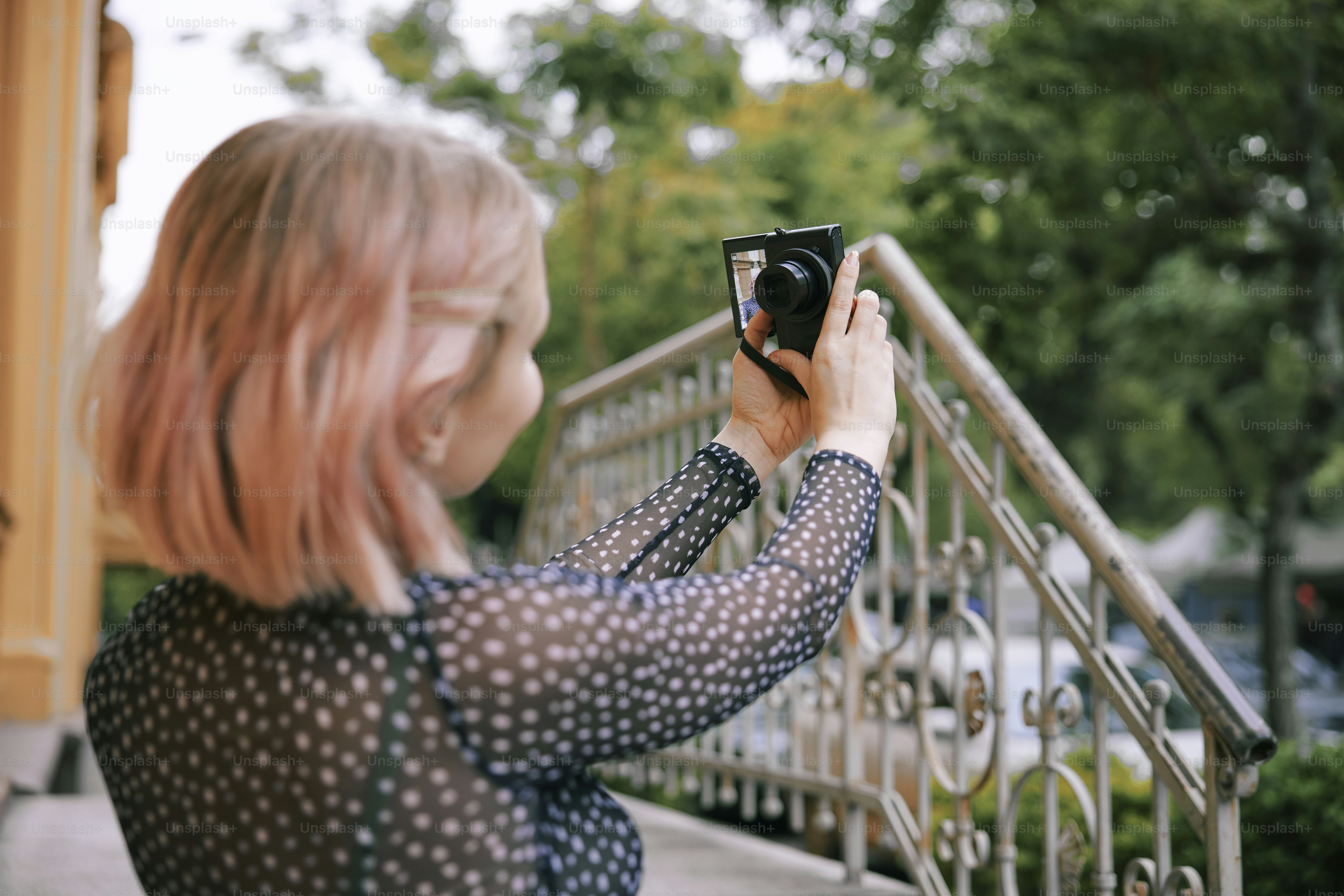 a woman taking a picture of herself with a camera