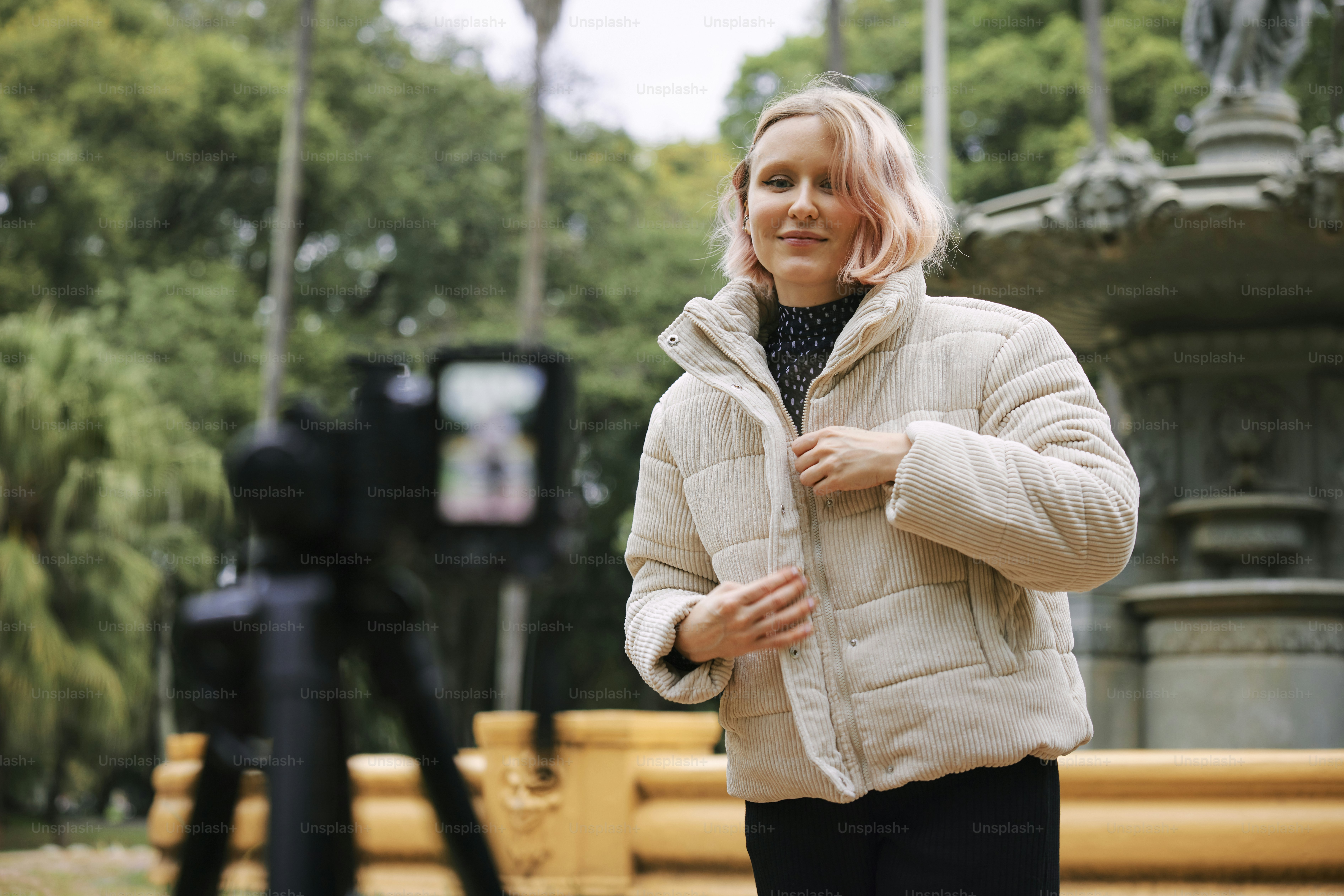 a woman standing in front of a fountain