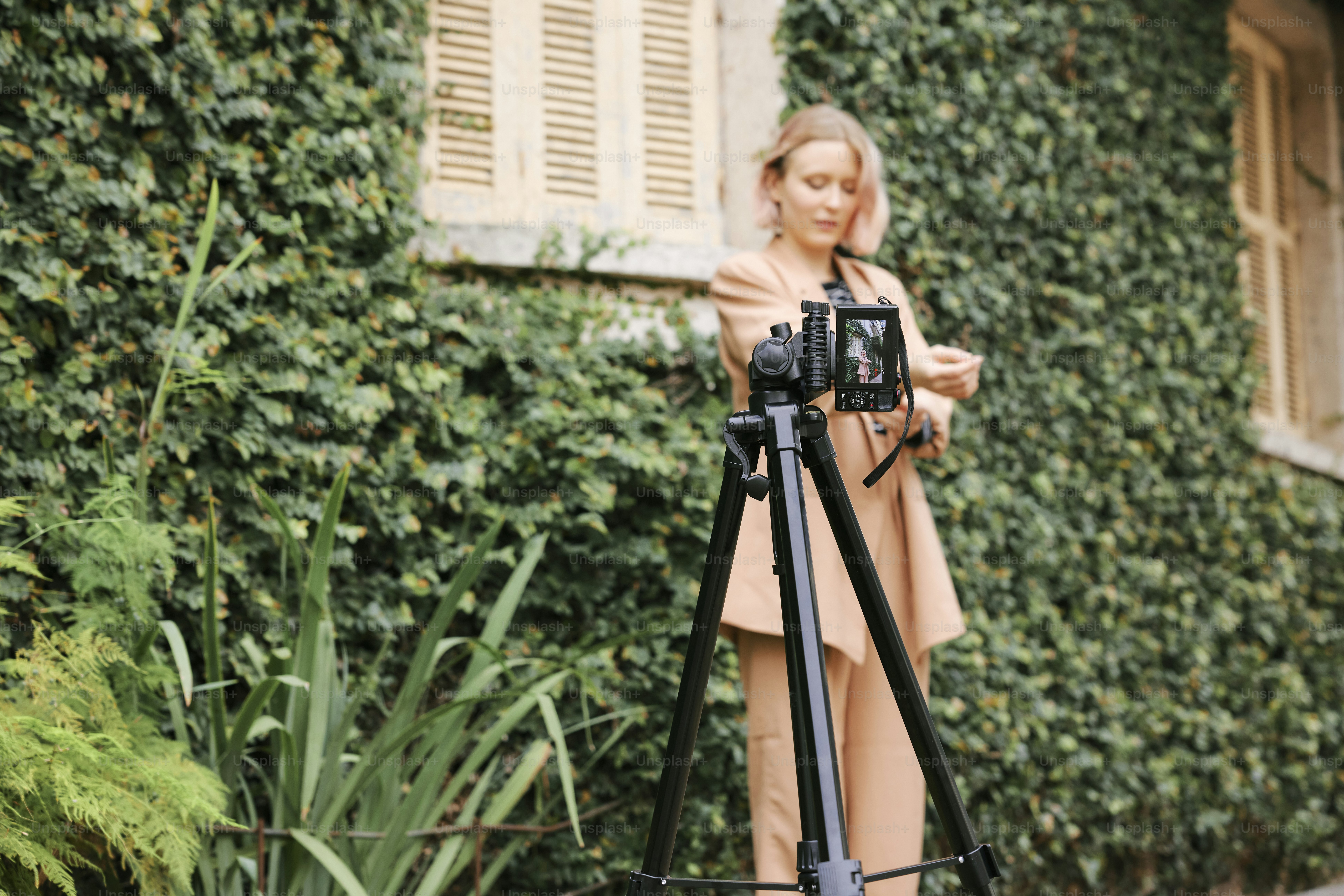 a woman standing in front of a camera