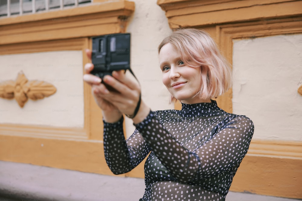 a woman taking a picture with her cell phone