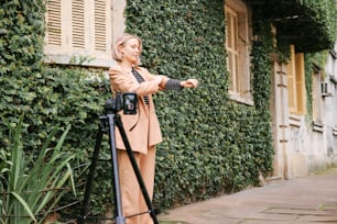 a woman standing in front of a green wall