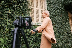 a woman standing in front of a green wall