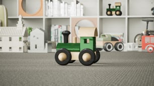 ein grüner Spielzeugtraktor, der auf einem Teppich sitzt