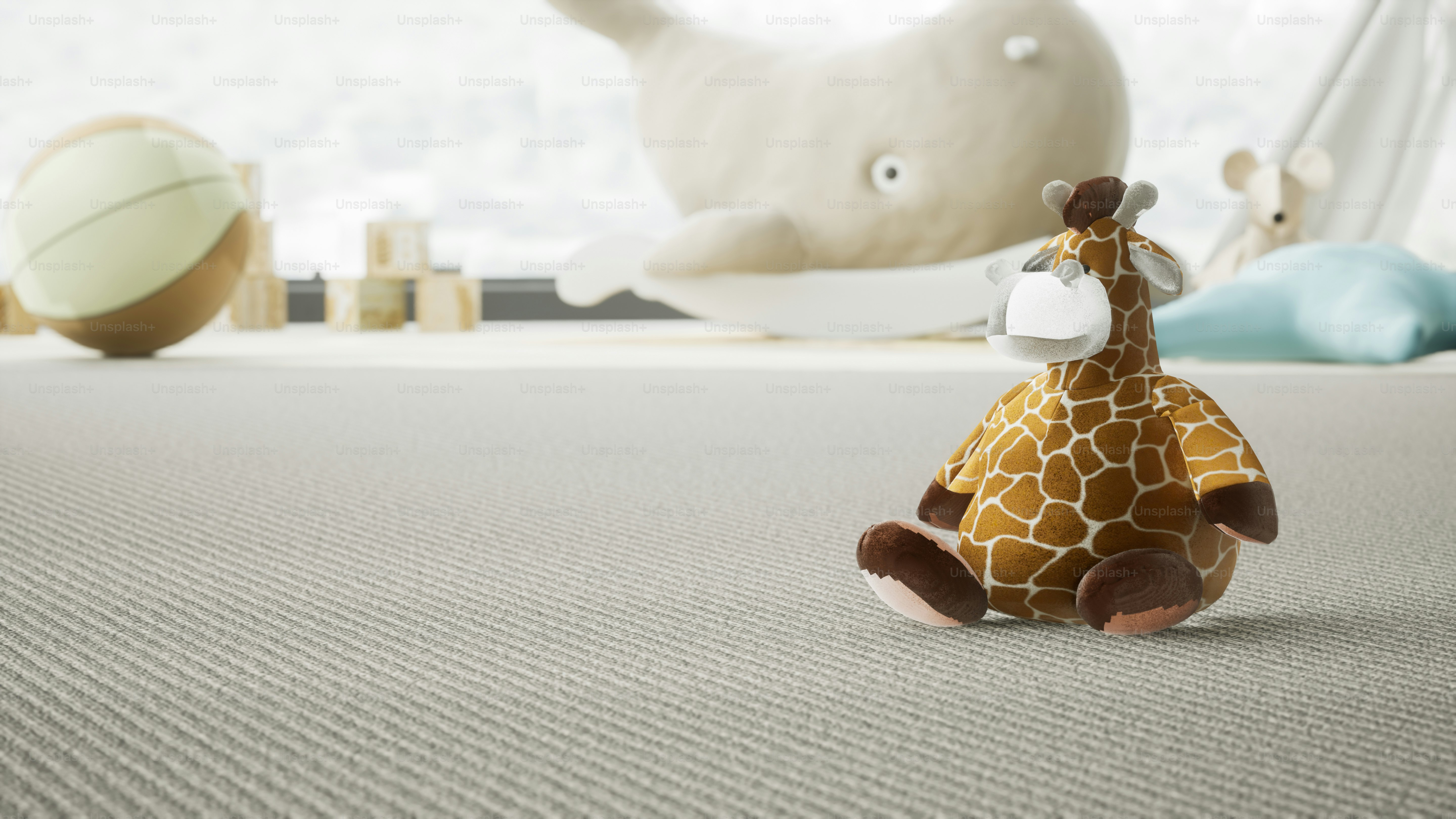 a giraffe stuffed animal sitting on top of a bed