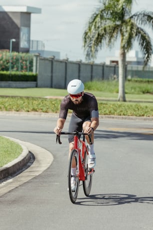 a man riding a red bike down a street