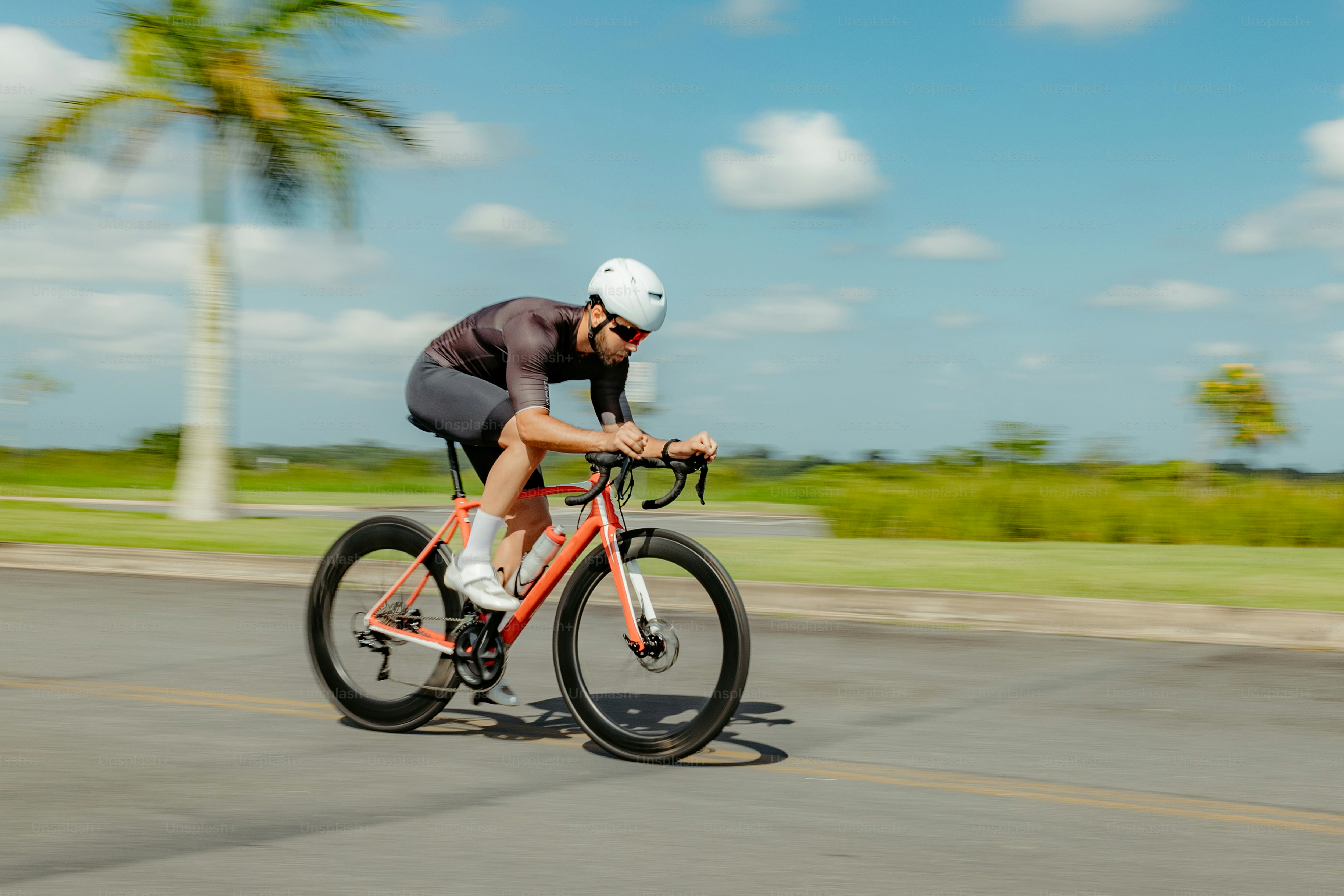 a man riding a bike down a street