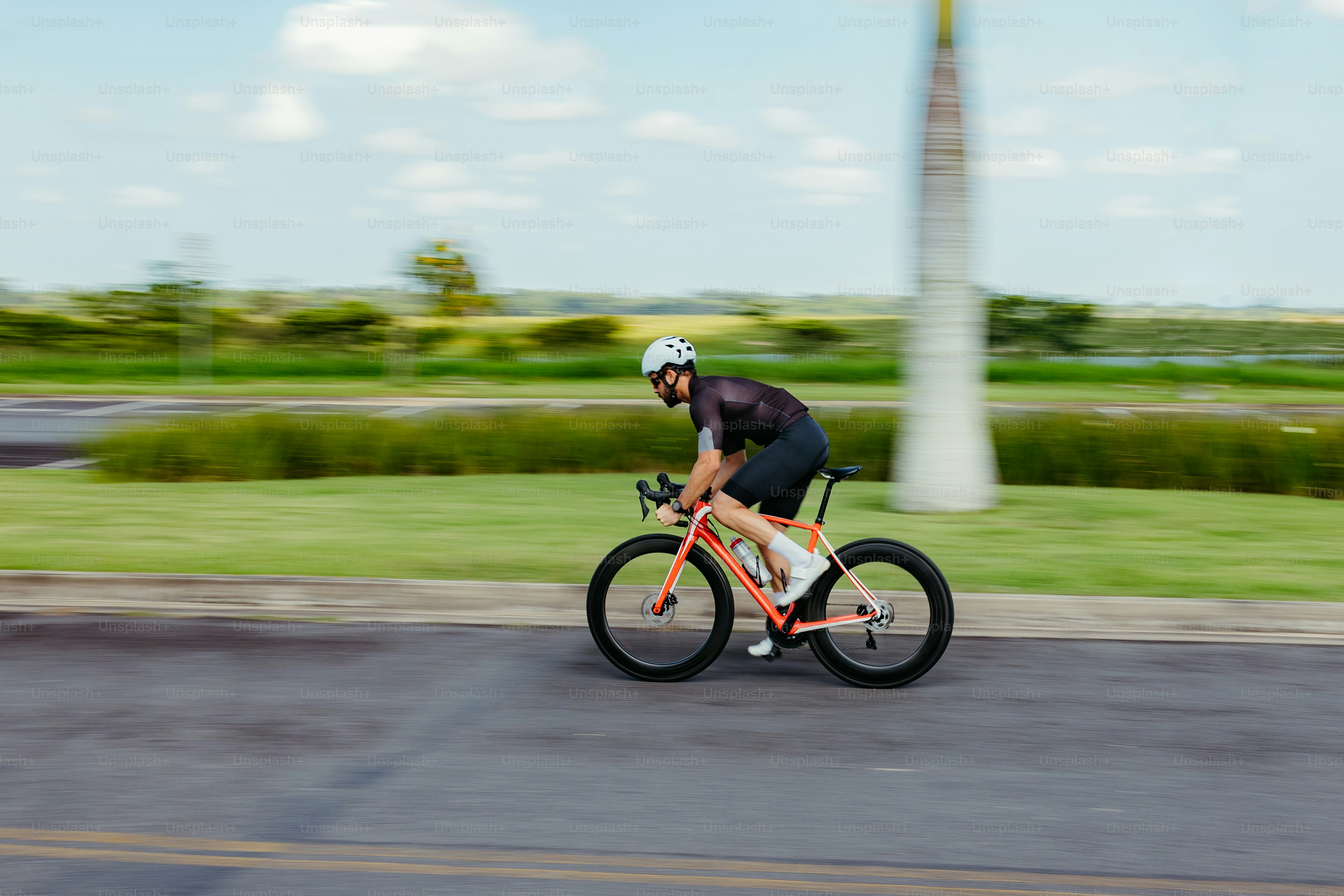 a man riding a bike down a street
