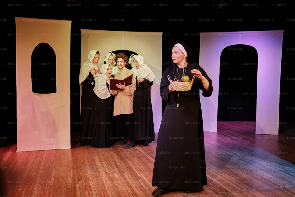 a woman standing on a stage holding a basket